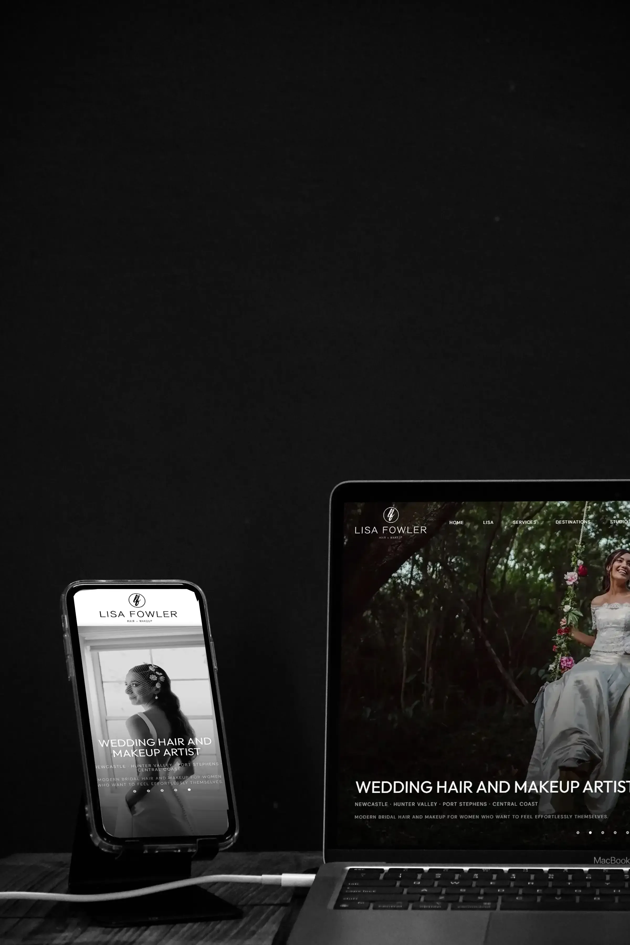 The Lisa Fowler Hair + Makeup home page running on a phone and a laptop side by side on a dark desk.